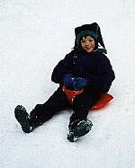 Smith going down the slopes on a sled